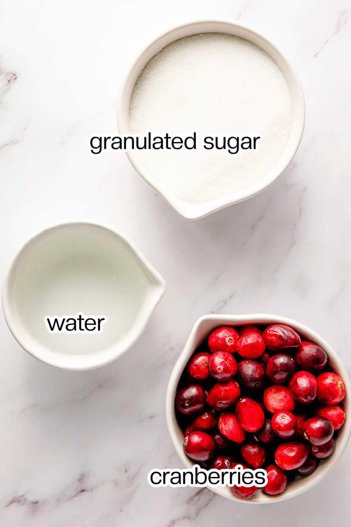 Ingredients for making sugared cranberries on a table.