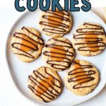 A plate of turtle cookies on a table with caramels scattered around.