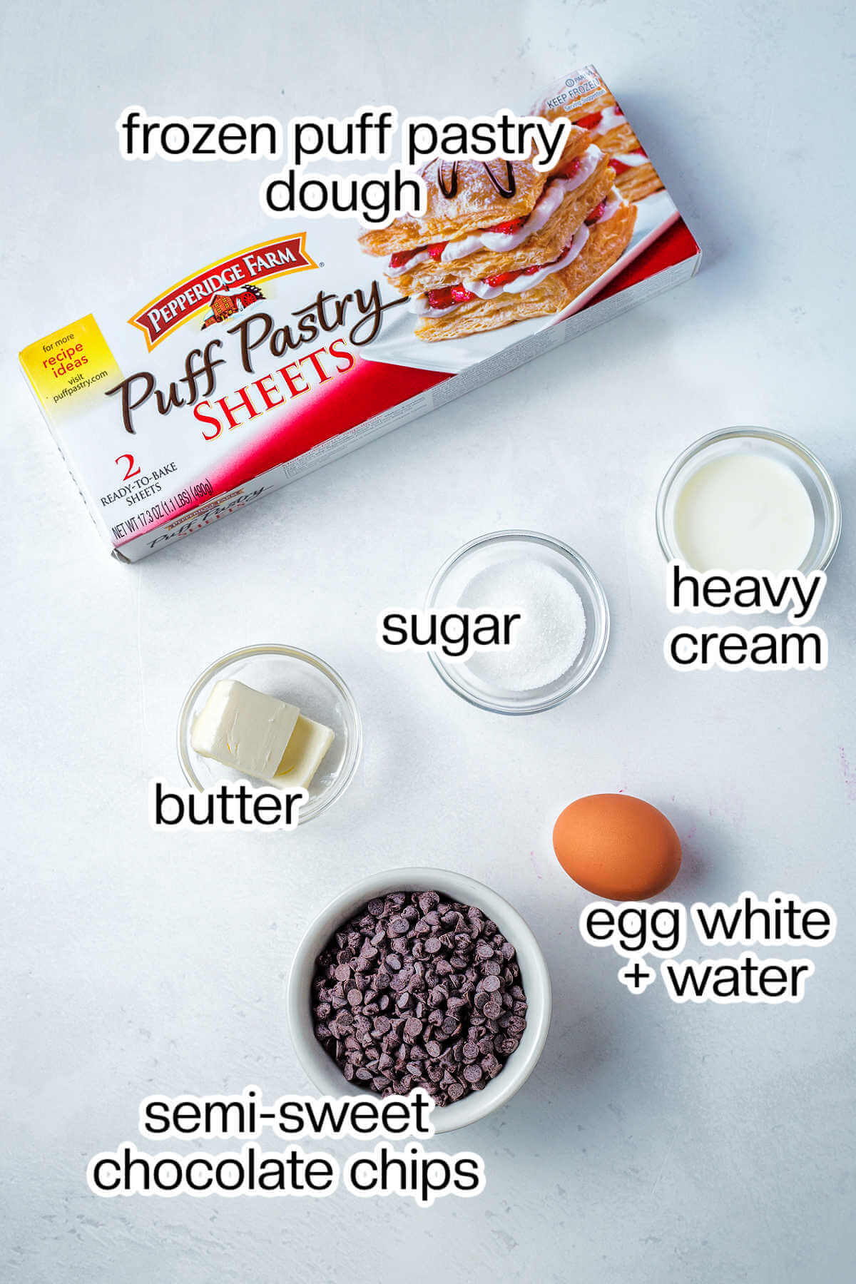 Ingredients for puff pastry chocolate twists on a table.