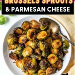 Brussels Sprouts and Parmesan Cheese in a serving bowl with a spoon.