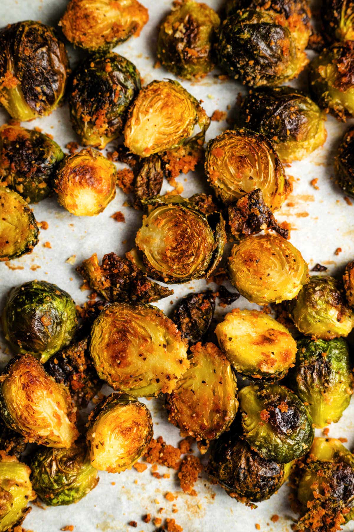 Brussels sprouts on a parchment-lined baking sheet.