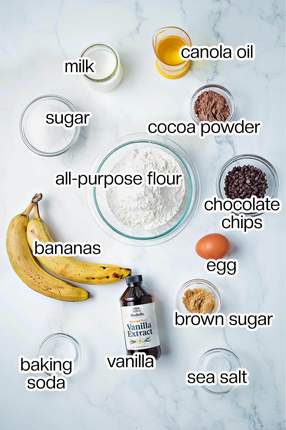 Ingredients for double chocolate banana muffins on a table.