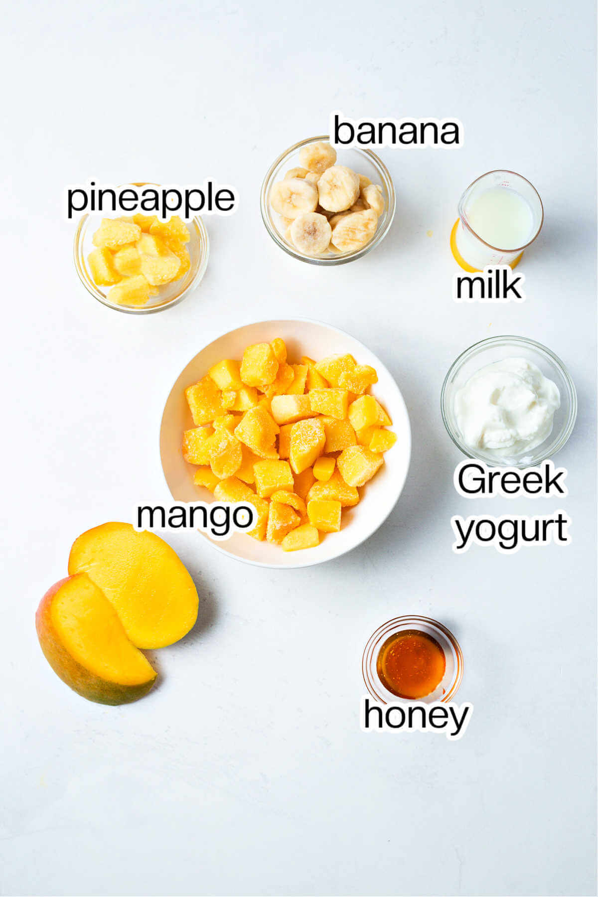 Ingredients for mango smoothie on a table.