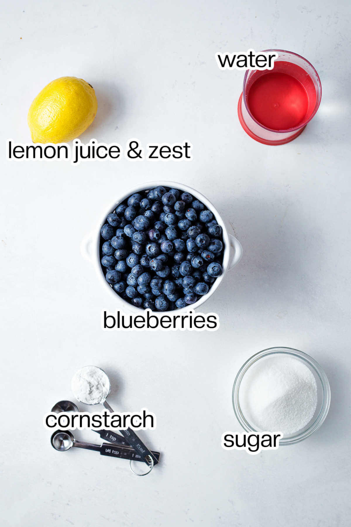 Ingredients for blueberry syrup on a table.