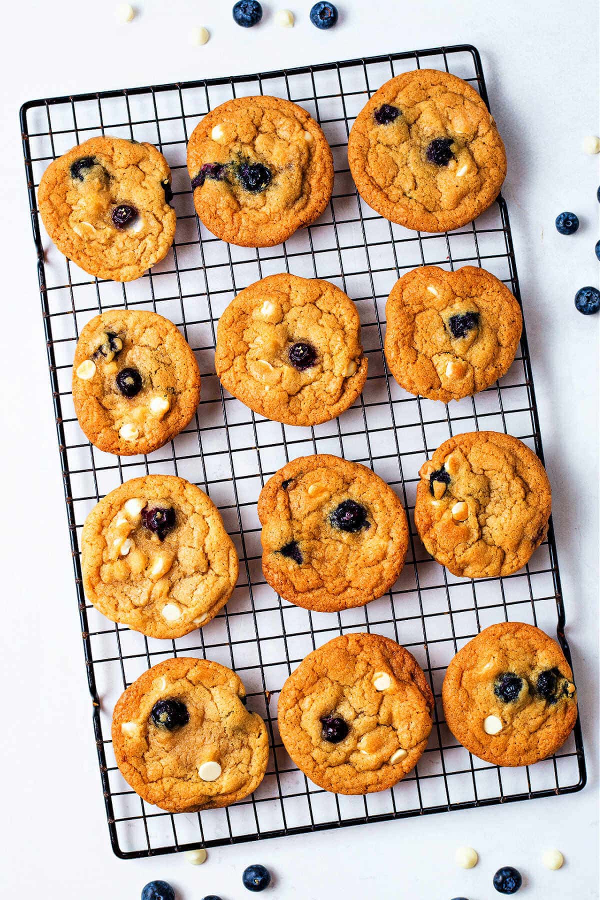 Overhead shot of blueberry cookies on a cooling rack.