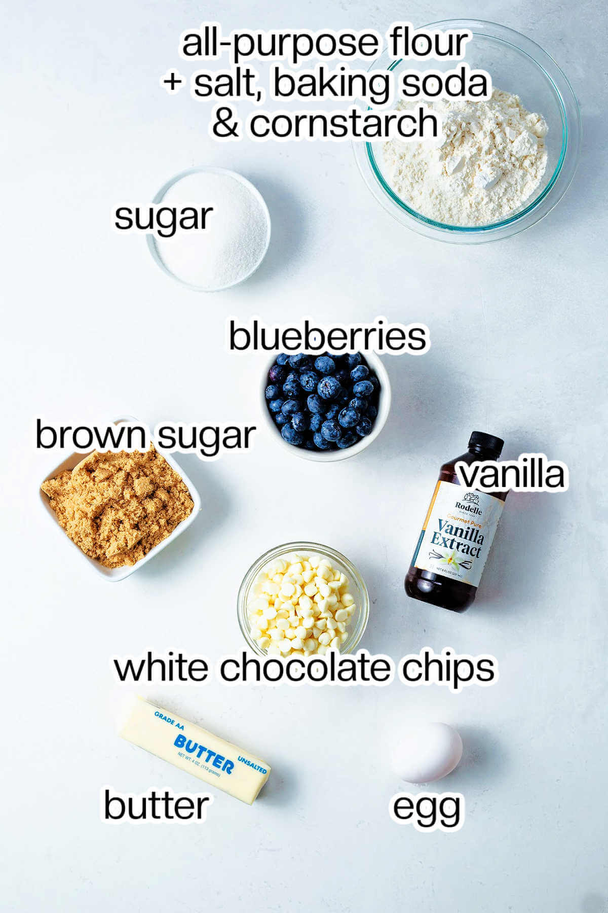 Ingredients needed to make blueberry cookies with white chocolate chips.