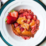 strawberry cobbler serving in a bowl.