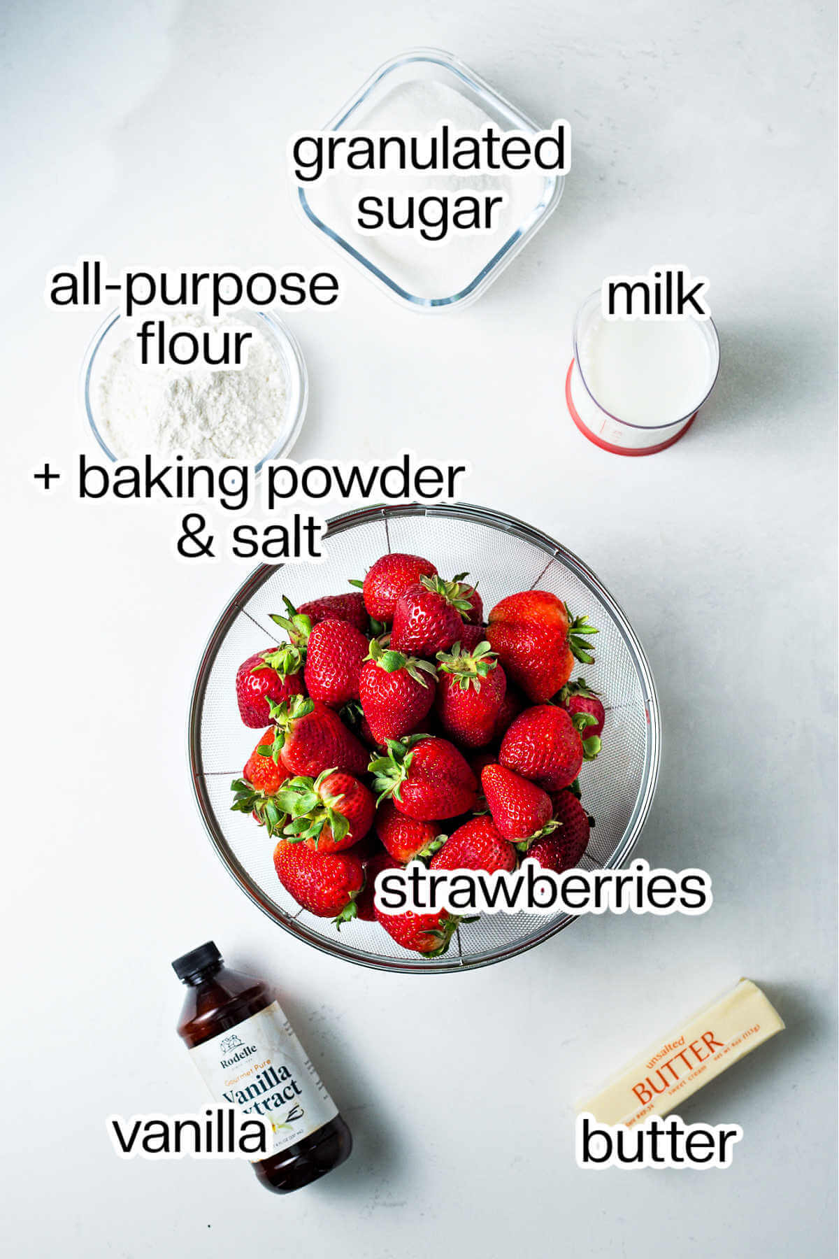 Ingredients for strawberry cobbler on a table.