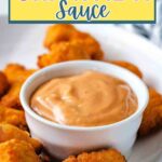 Chick Fil A sauce in a small bowl on a platter with chicken nuggets.