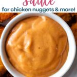 Chick Fil A sauce in a small bowl on a platter with chicken nuggets.