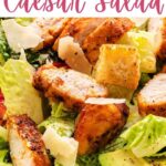 Blackened Chicken Caesar Salad on a plate on a table.