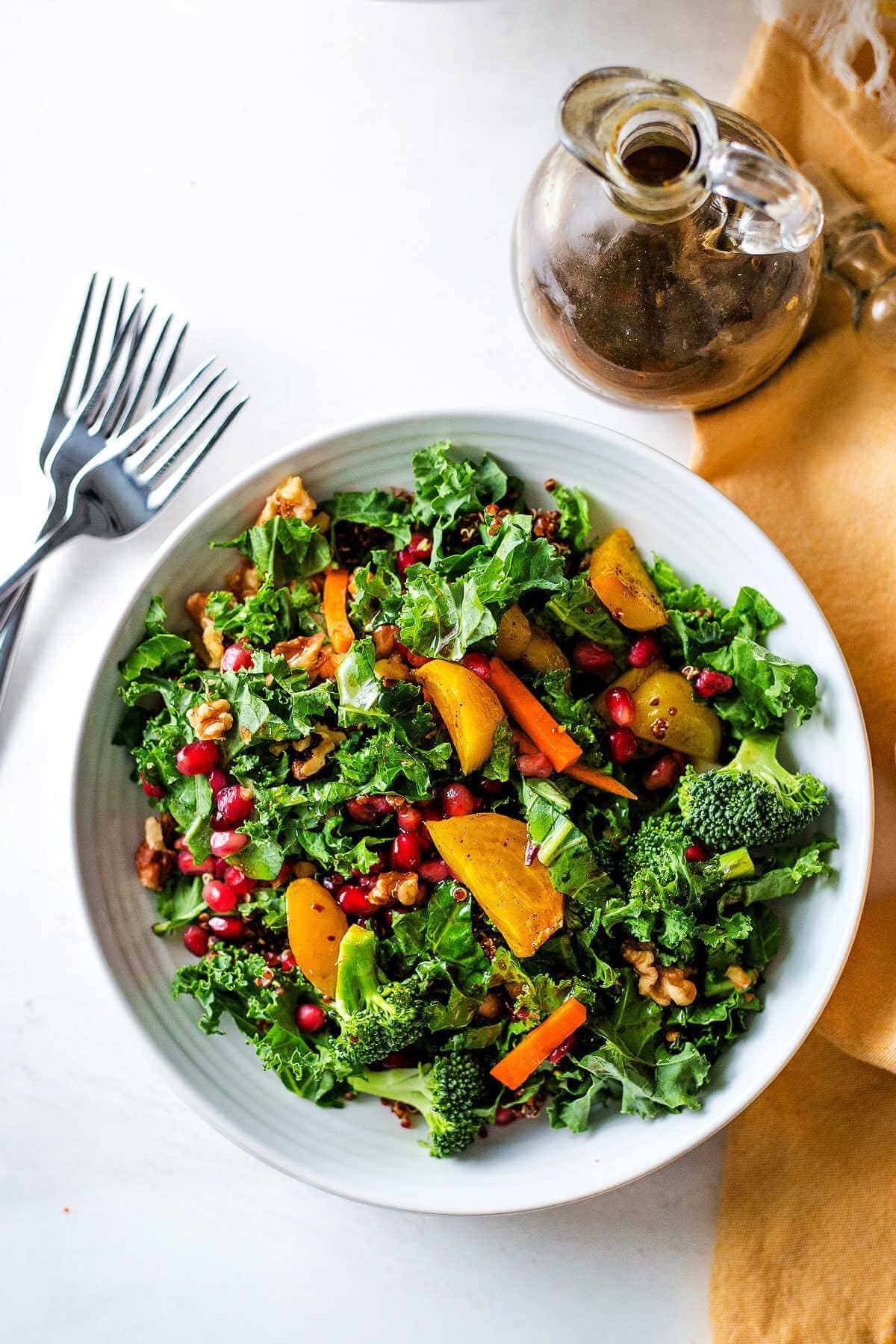 Super food salad with sesame ginger dressing served in a bowl with dressing on the side.