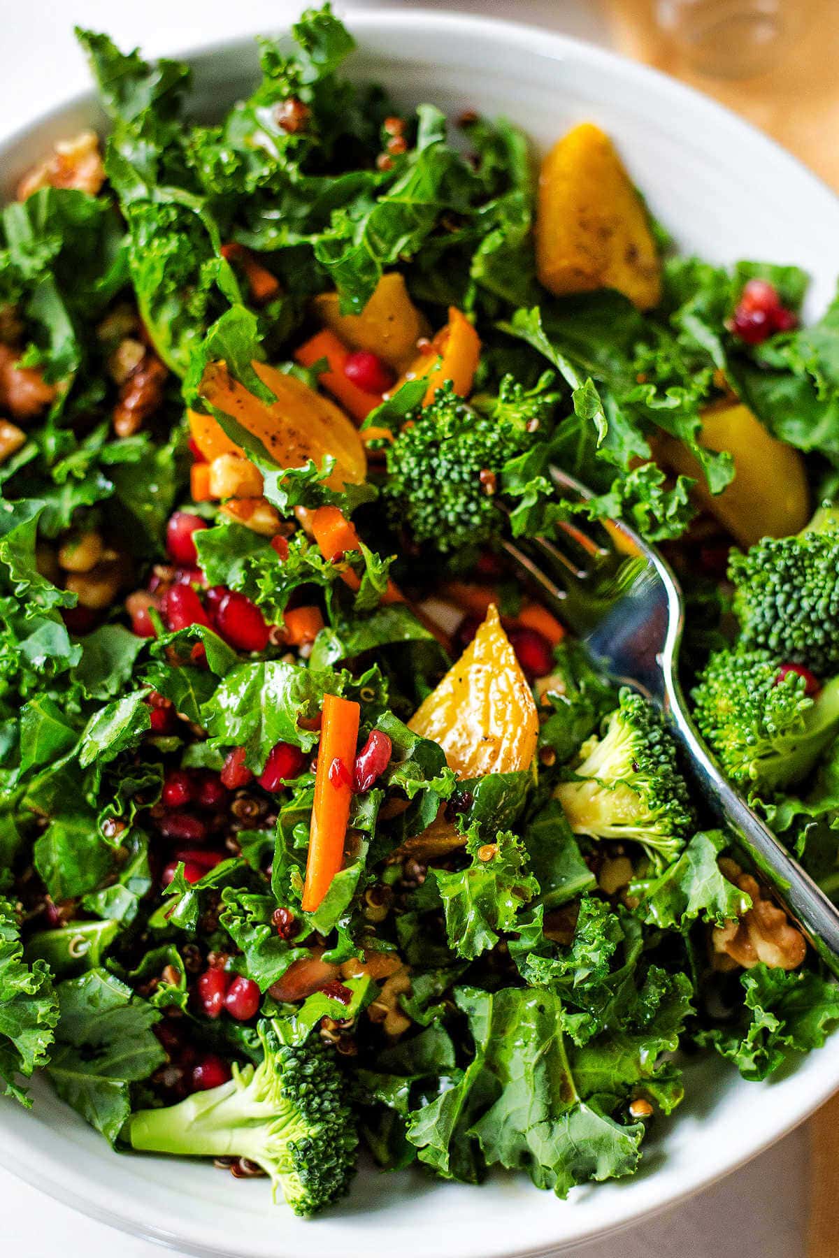 Super food salad dressed with sesame ginger dressing in a bowl with a fork.