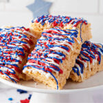 Krispy Treats decorated with red, white, and blue candy melts and sprinkles.
