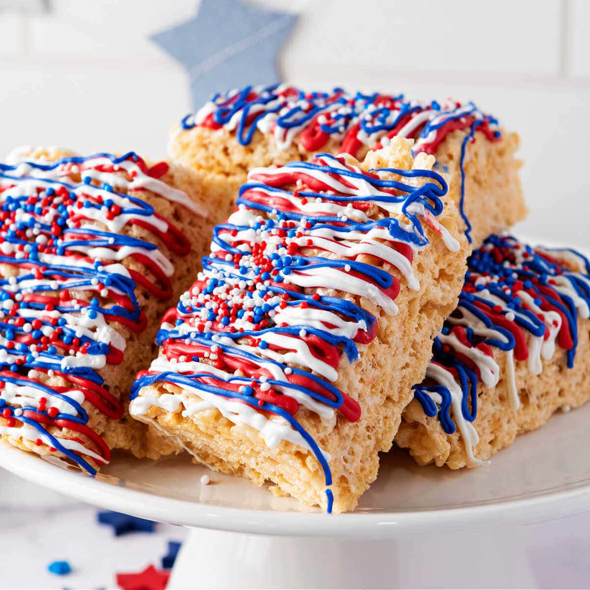Krispy Treats decorated with red, white, and blue candy melts and sprinkles.