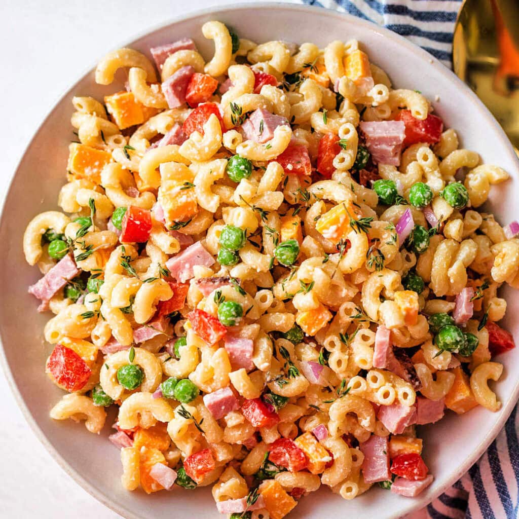 Easy macaroni salad with peas and ham in a bowl.