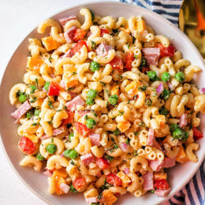 Easy macaroni salad with peas and ham in a bowl.