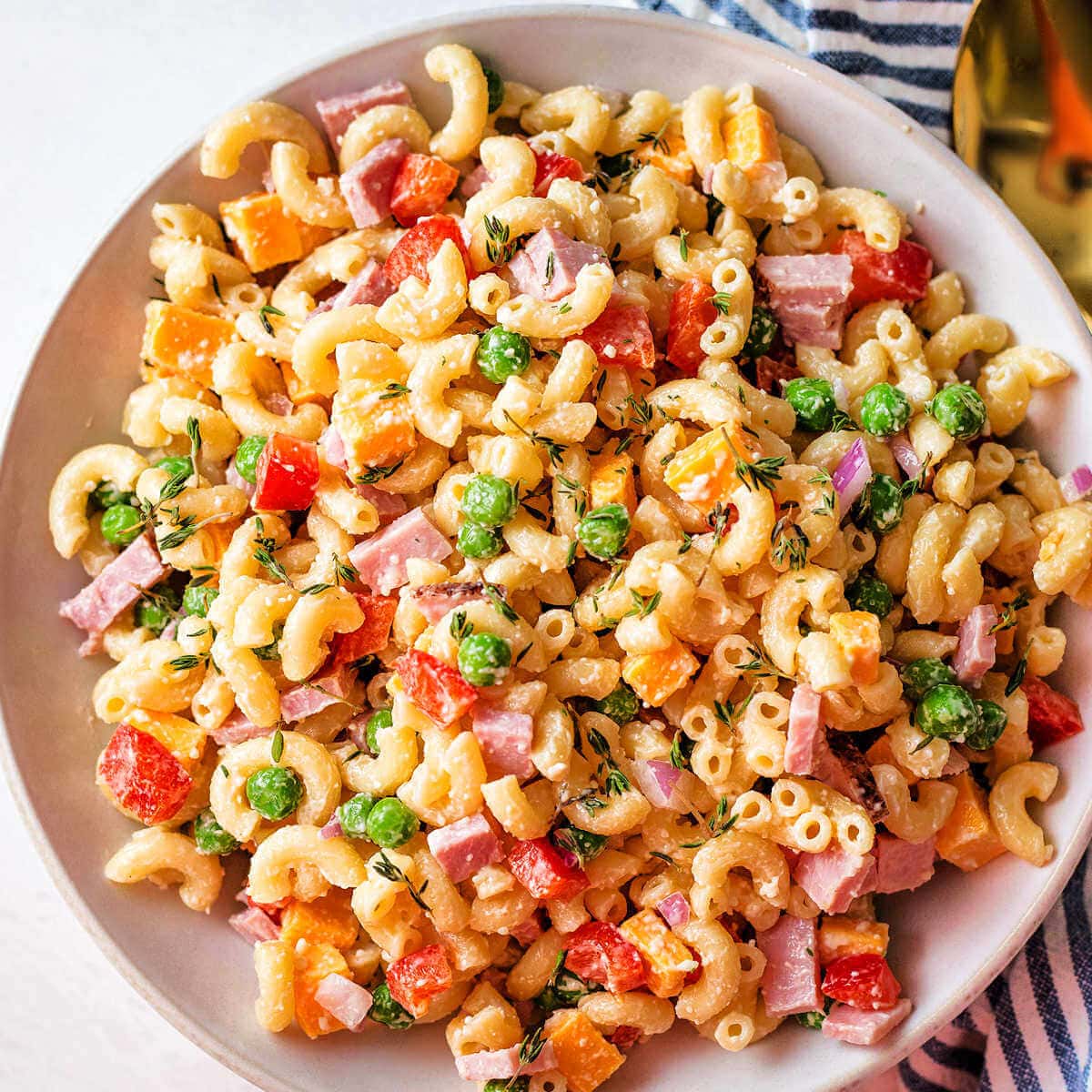 Easy macaroni salad with peas and ham in a bowl.