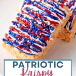 Patriotic Krispy Treats decorated with red, white, and blue drizzle and sprinkles on a plate.
