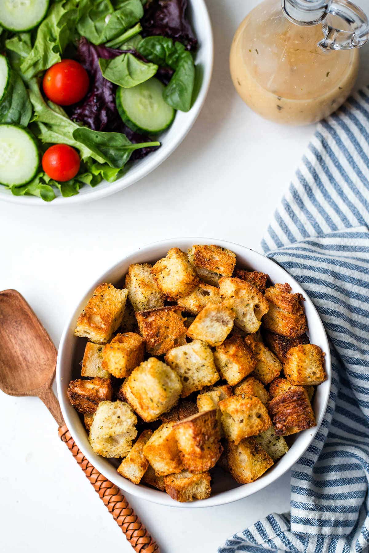 Overhead shot of air fryer croutons in a white bowl.