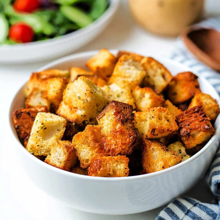 Homemade croutons made in the air fryer in a bowl on a table.