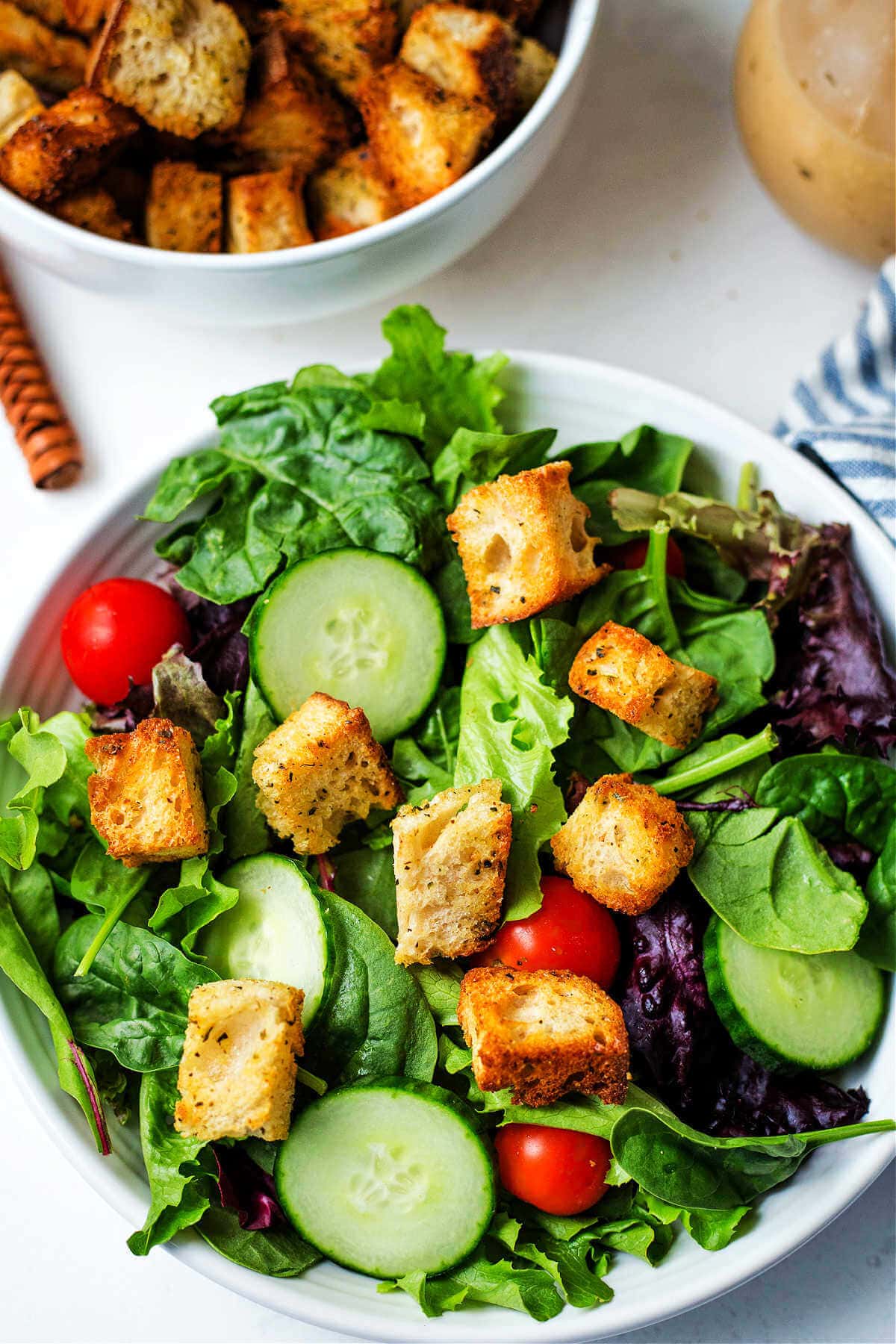 Green salad with homemade air fryer croutons on top.