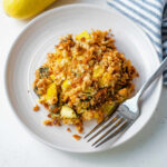 Portion of summer squash casserole on a white plate.