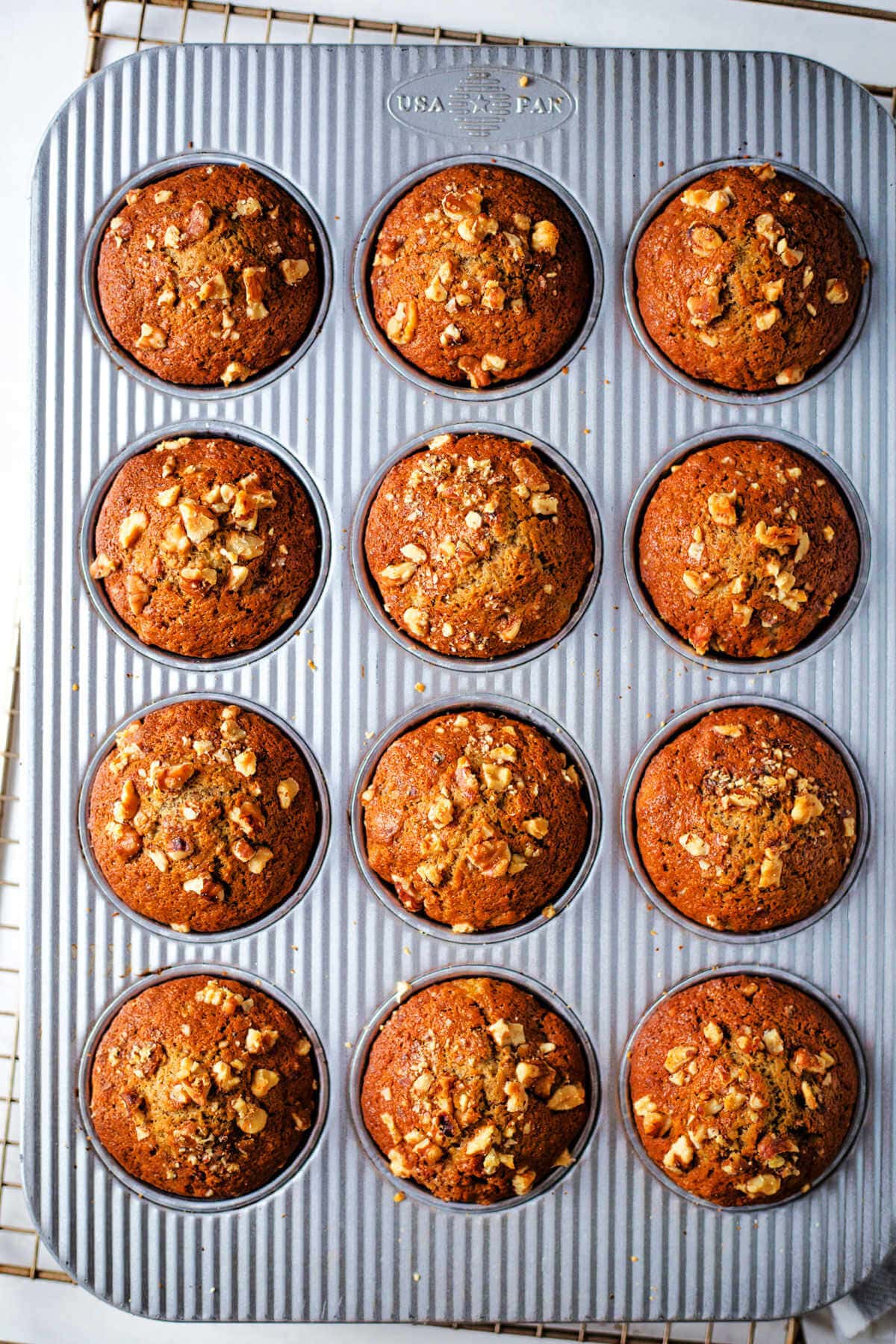 Baked banana nut muffins in a muffin tin.
