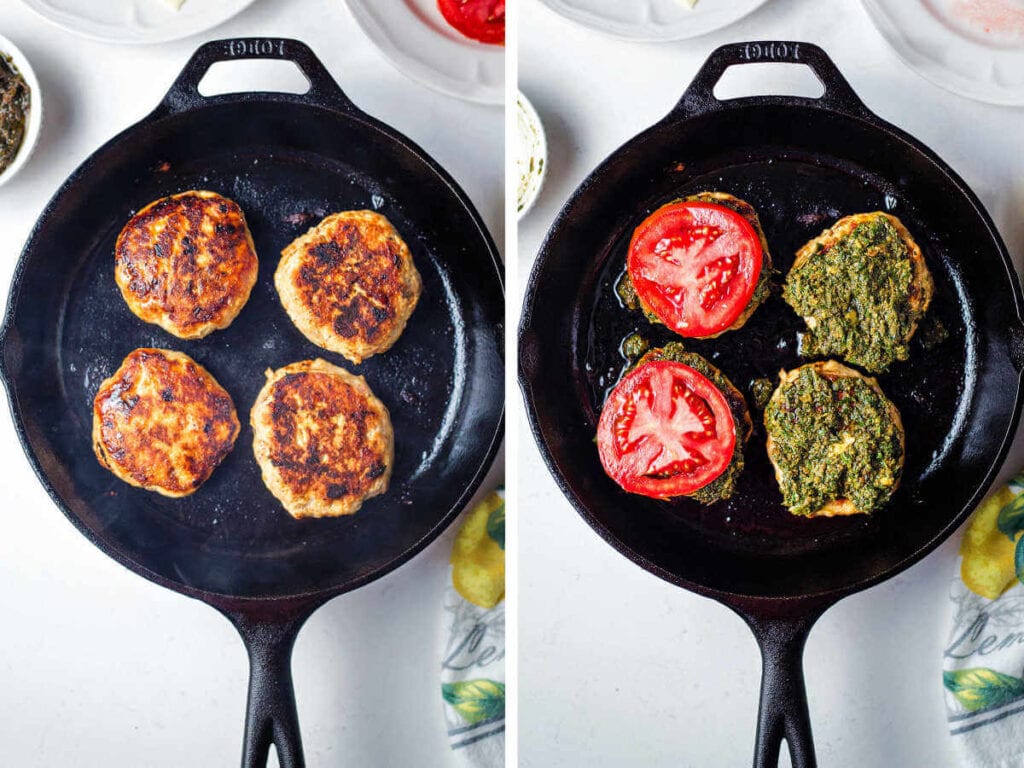 Topping the seared chicken burgers with pesto and tomato slices.