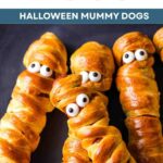 Halloween Mummy Dogs, Crescent Wrapped Hot Dogs on a plate.