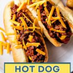 Two hot dogs topped with Hot Dog Chili and cheese.