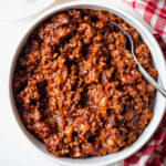 Homemade hot dog chili in a white bowl.