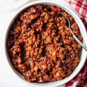 Homemade hot dog chili in a white bowl.
