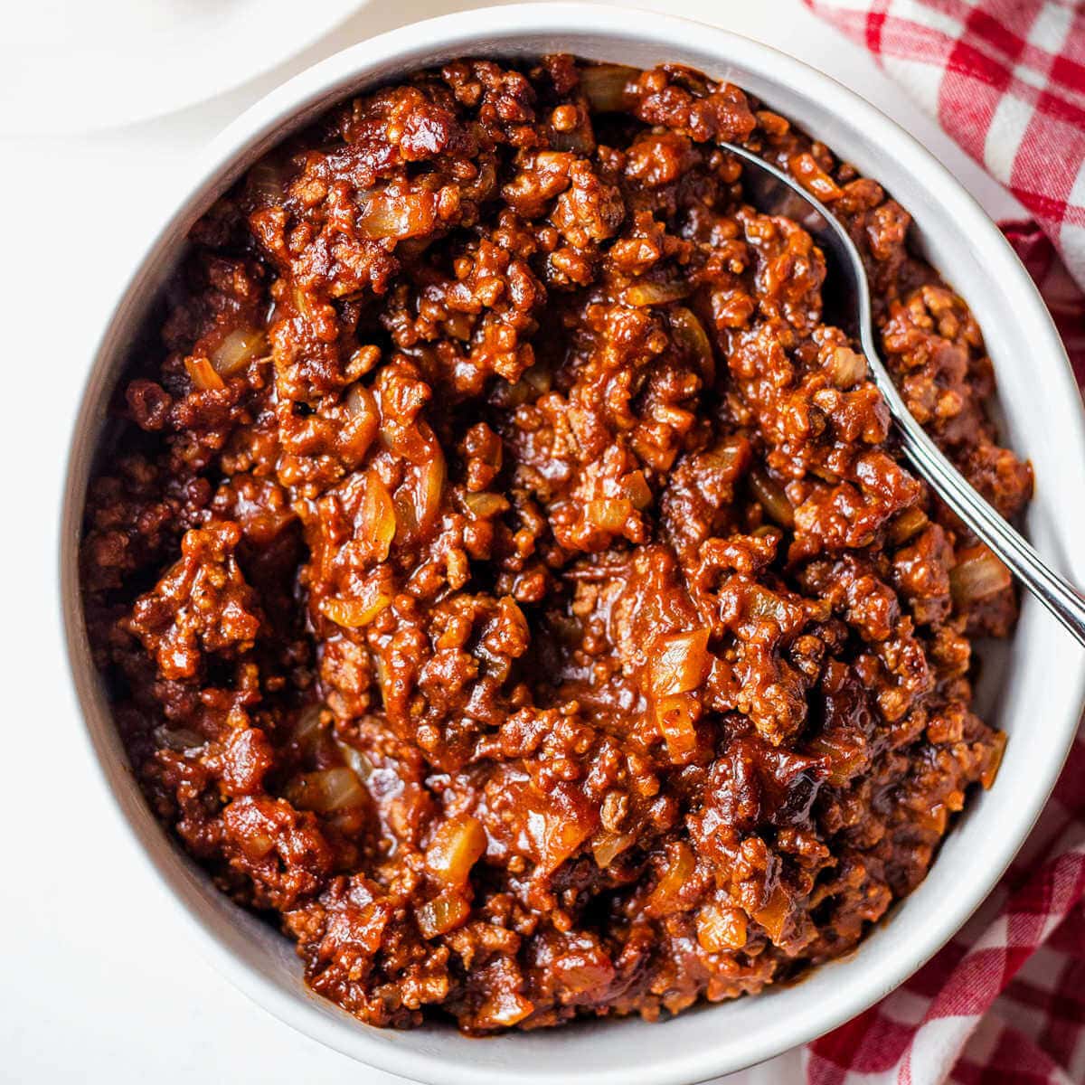 Homemade hot dog chili in a white bowl.