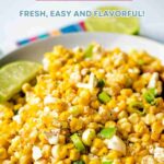 Mexican Corn Salad in a bowl garnished with fresh lime wedge.