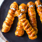 Crescent Wrapped Hot Dogs decorated as mummies for Halloween.