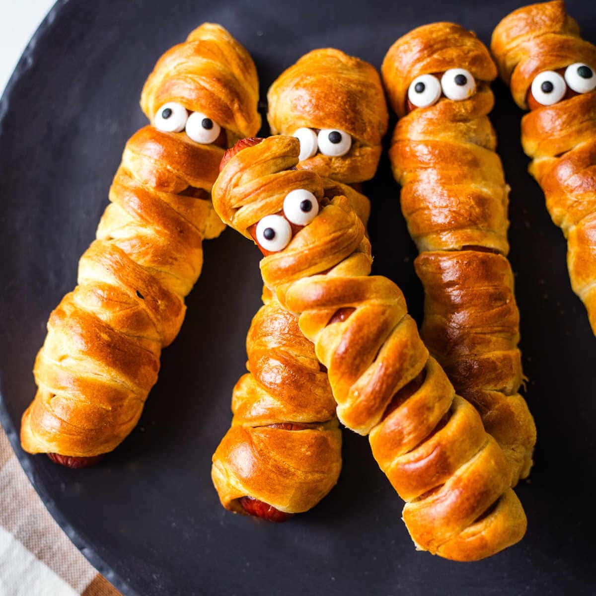 Crescent Wrapped Hot Dogs decorated as mummies for Halloween.