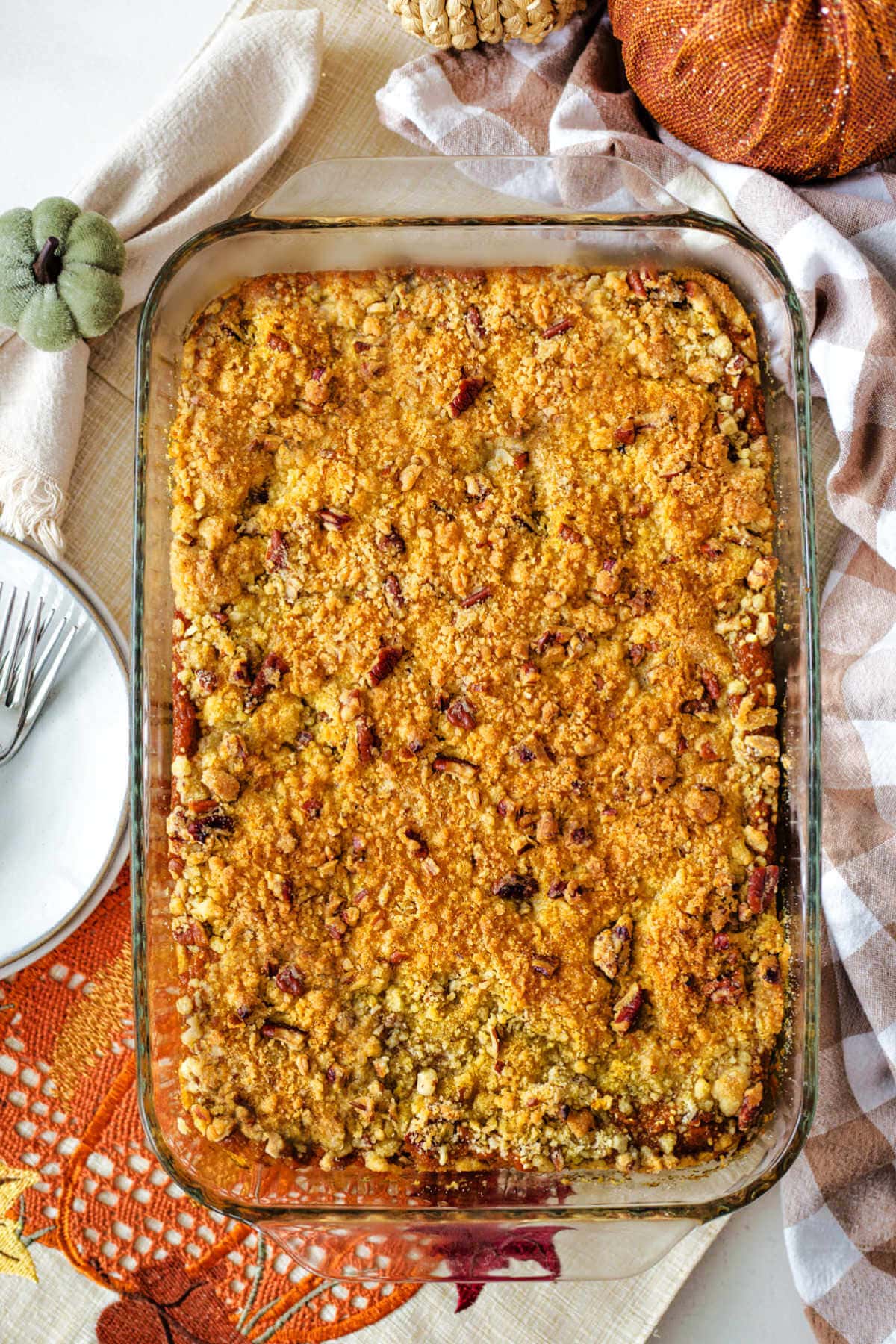 Overhead shot of a baked pumpkin dump cake in a glass baking dish.