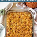 Pumpkin Dump Cake in a glass dish with a pecan crumble on top.