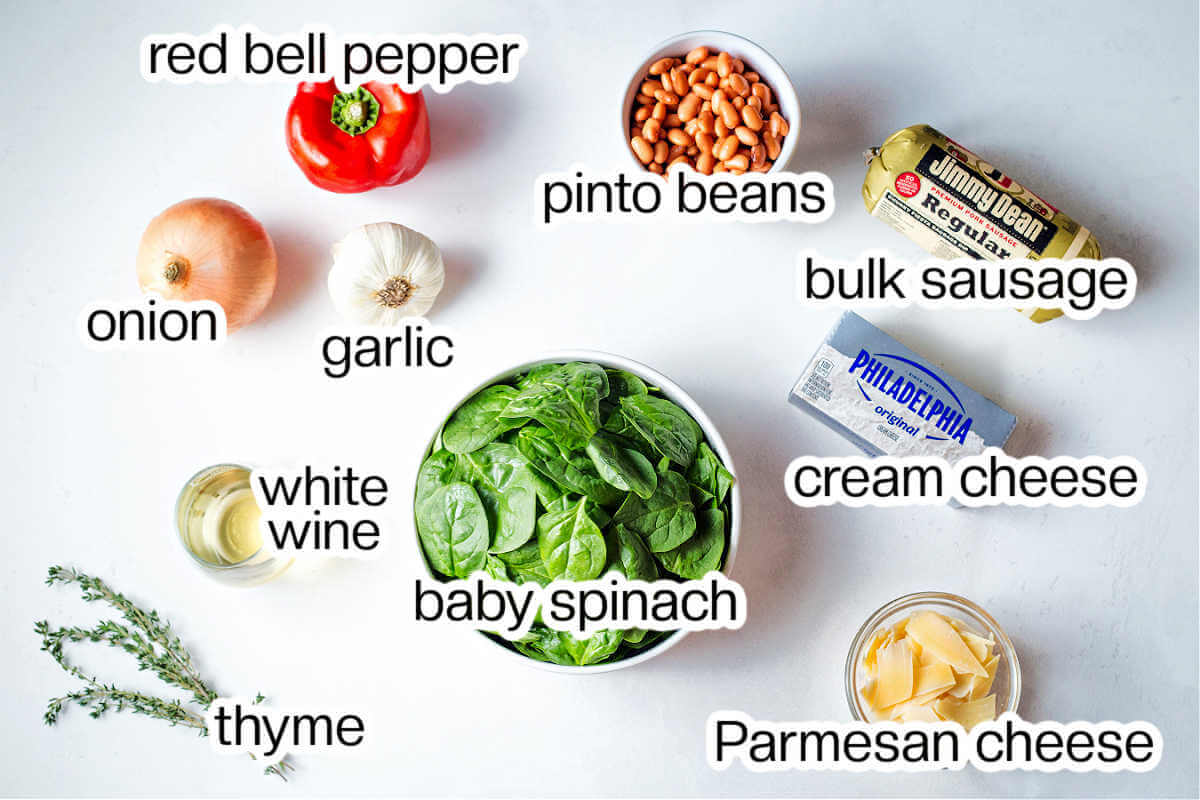 Ingredients needed to make cheesy sausage dip with beans and spinach.