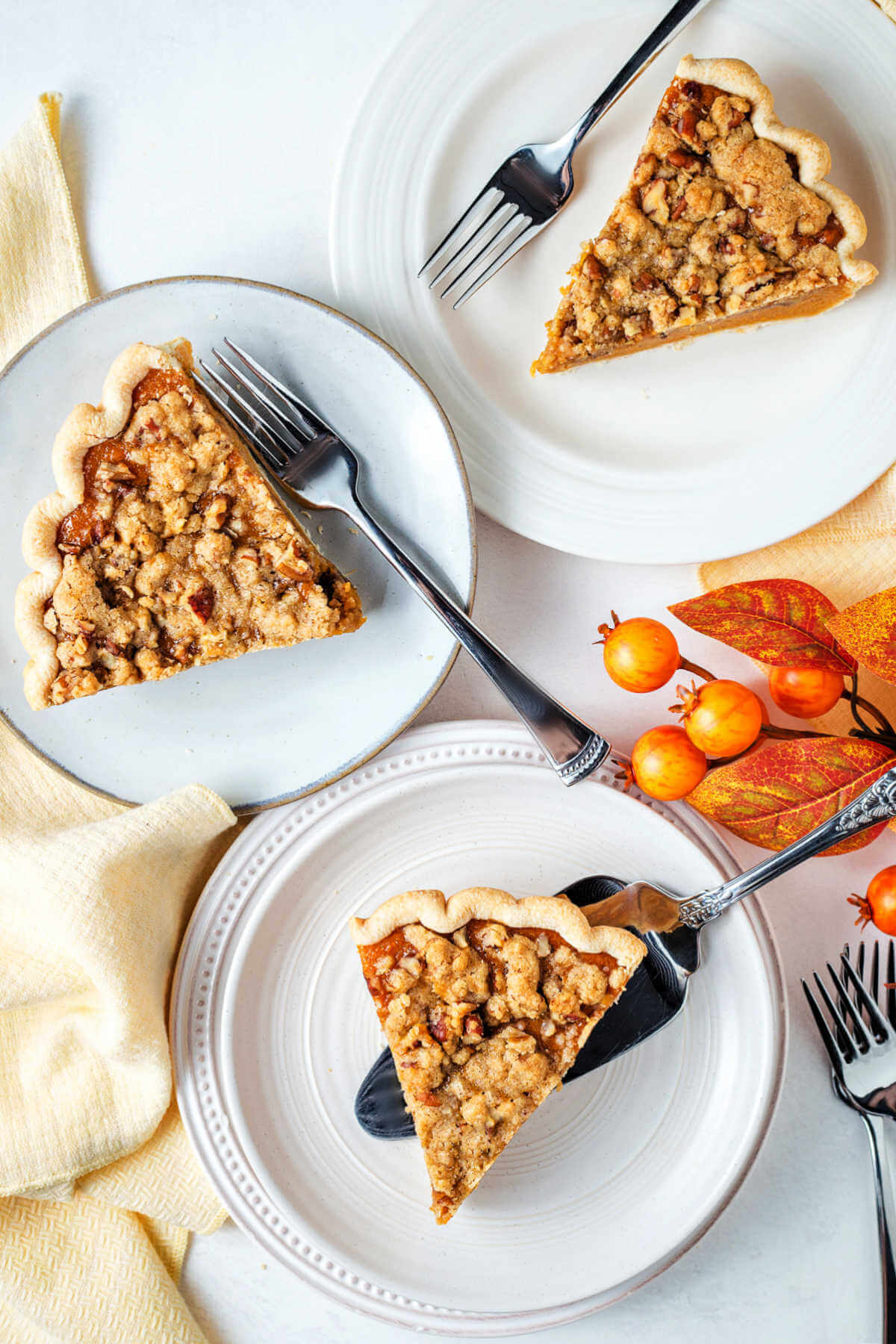 Three slices of sweet potato pie on plates.