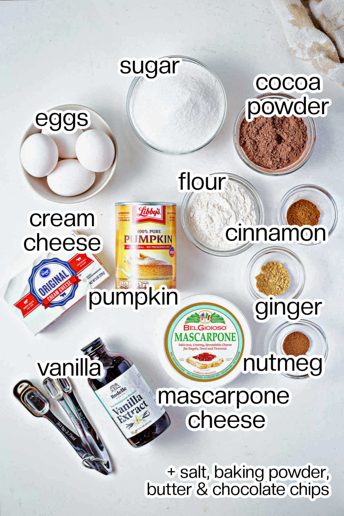 Ingredients for pumpkin cheesecake brownies on a table.