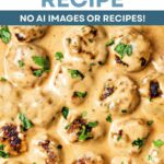 Swedish Meatballs and Gravy over noodles in a pan.