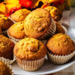 Pumpkin Muffins stacked on a plate.