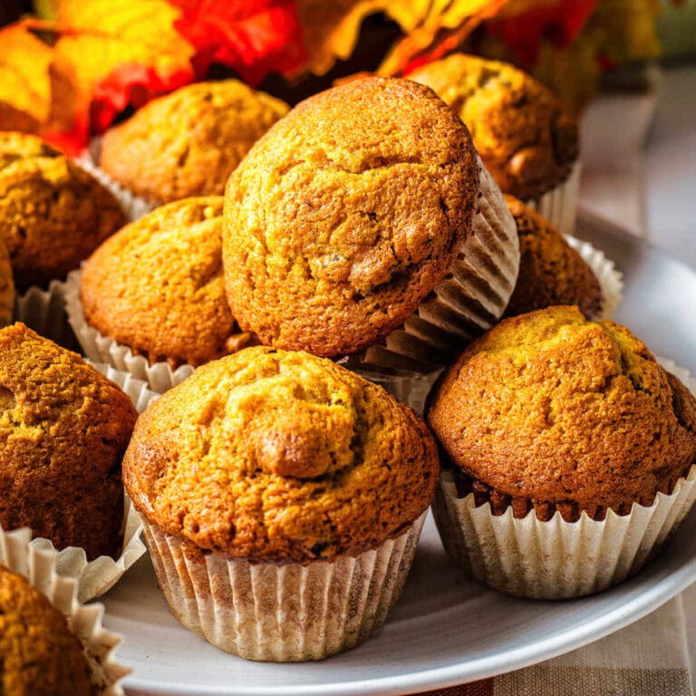 Pumpkin Muffins stacked on a plate.