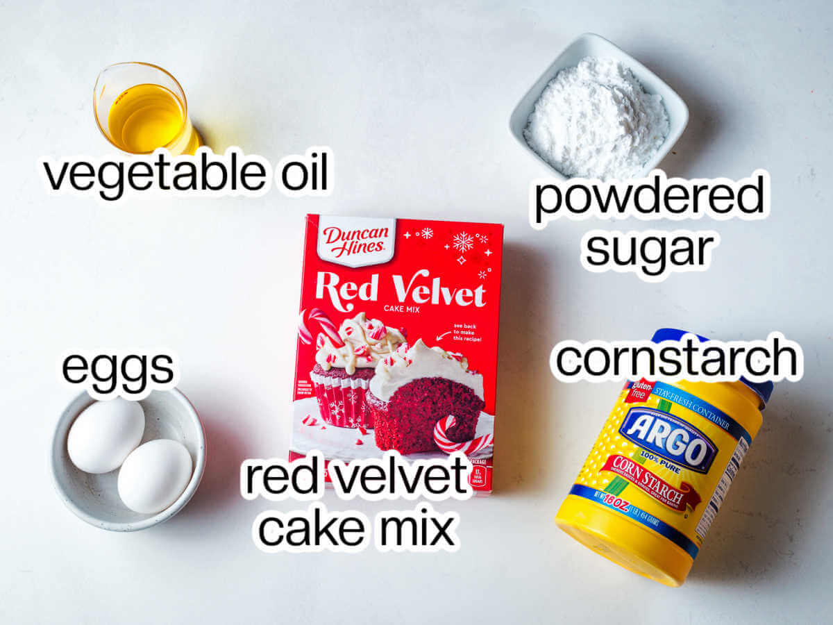 Ingredients needed to make red velvet cake crinkle cookies.