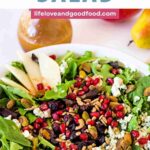 Christmas Salad with pears, pistachios, cranberries, in a bowl on a table.