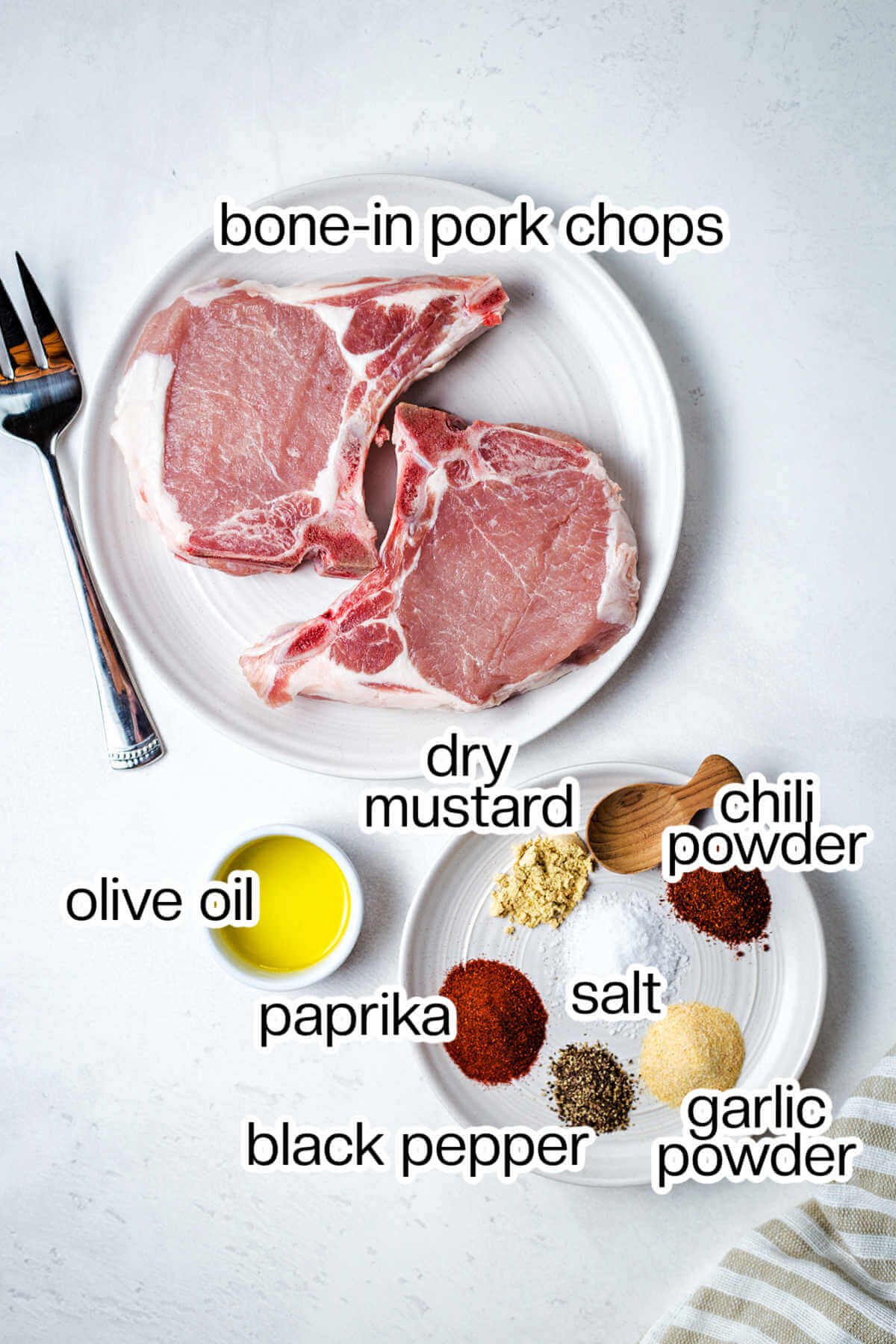Ingredients for making pork chops in the air fryer on a table.