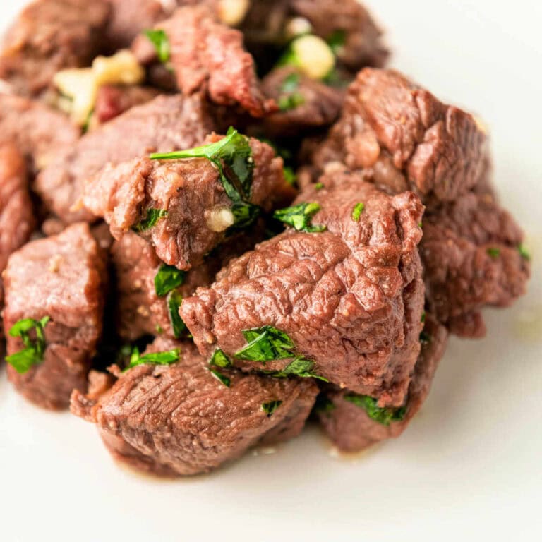 Air fryer steak bites piled on a plate.