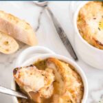 French Onion Soup in a bowl with cheesy toast on top.